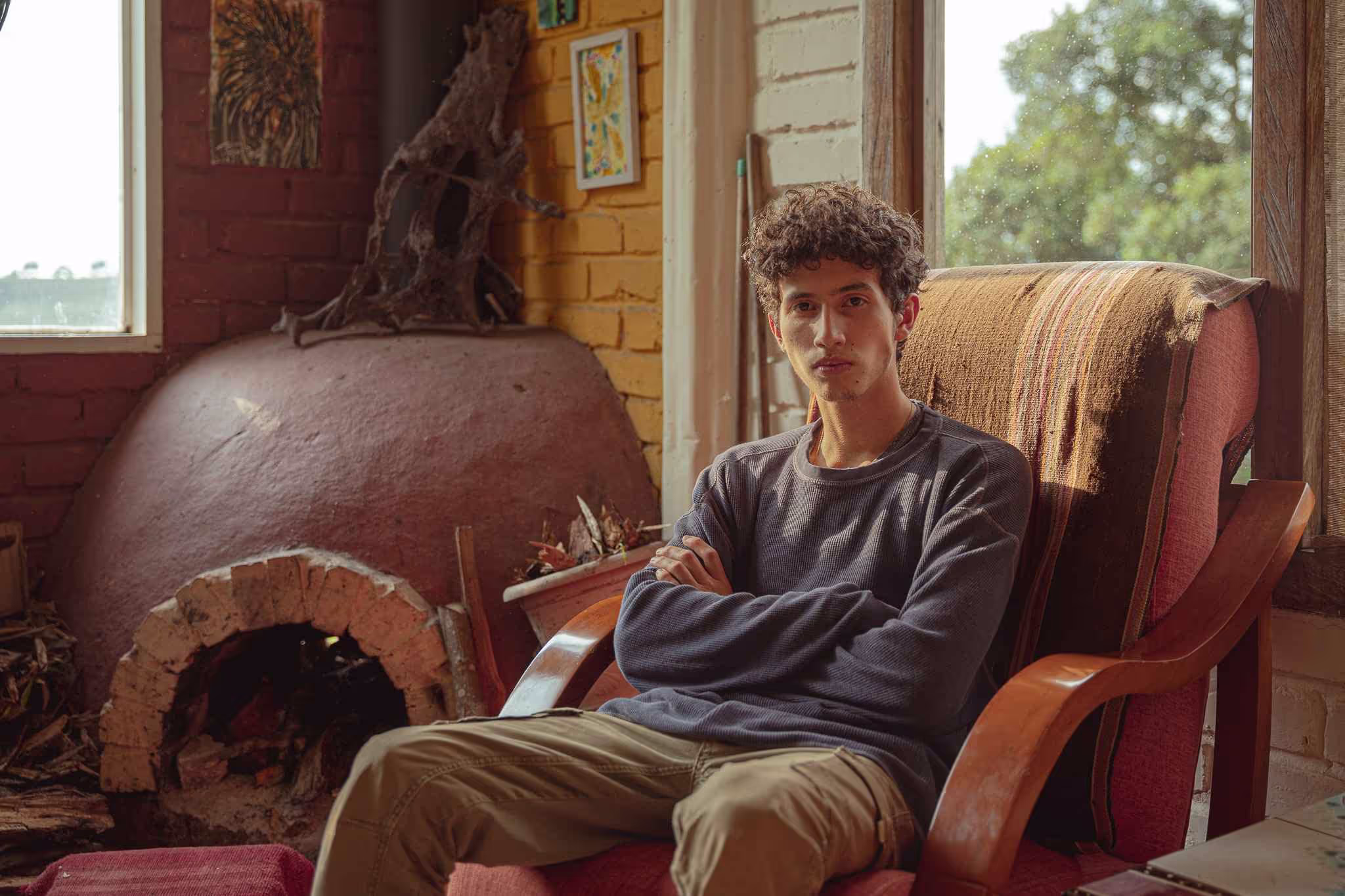 Pablo Pineda Sitting In A Rustic Living Room With A Fireplace In The Background.